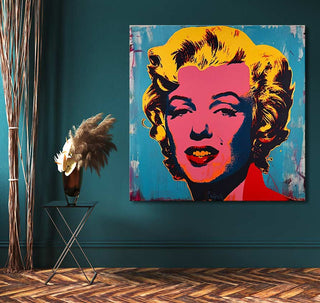 Andy Warhol signature - Marylin Monroe 4 pop-art painting on teal wall, with black-metal side table and vase, enhancing modern interior decor.