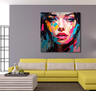 Françoise Nielly-signature painting Inga in the Morning in a modern living room, featuring a vibrant abstract portrait above a yellow sectional sofa.