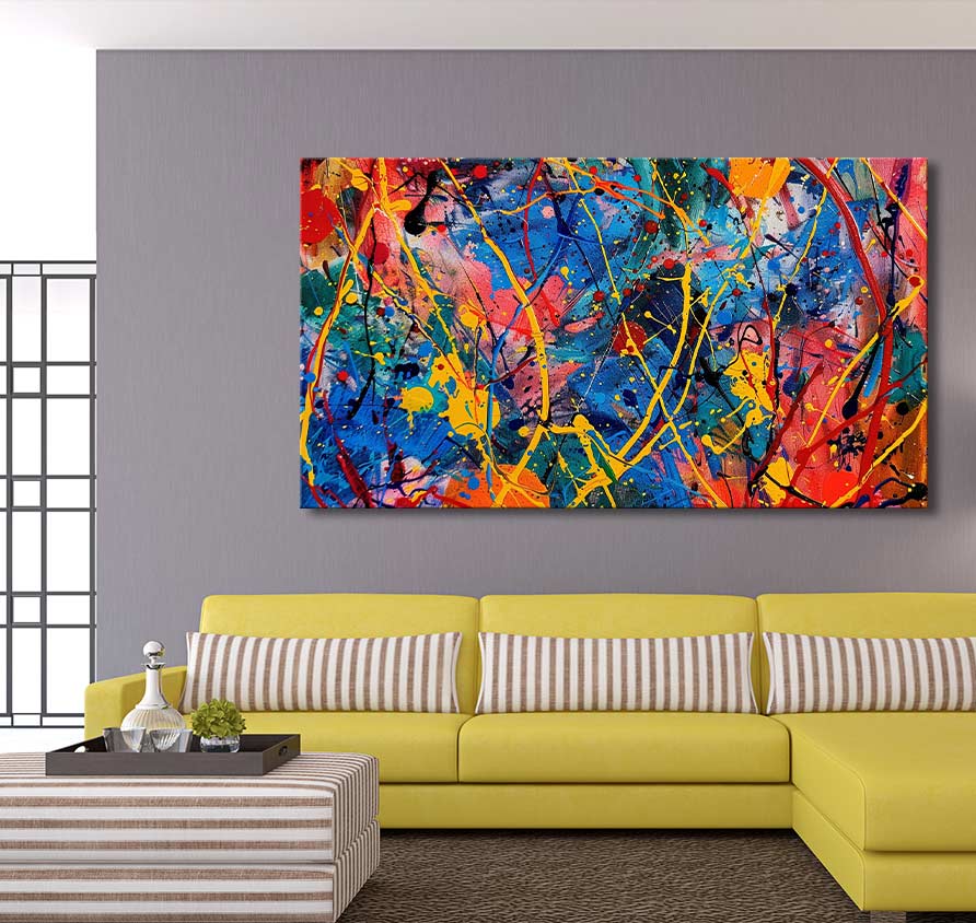 Jackson Pollock signature - Candy Shop: vibrant, abstract splatter-paint canvas with bold colors, ideal for modern interiors, displayed above a yellow L-shaped sofa.