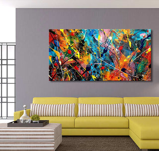 Abstract canvas Beach Days by Jackson Pollock, featuring vibrant splashes, hangs above a chartreuse L-shaped sofa, creating a dynamic living room focal point.