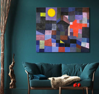 Paul Klee's Fire at Full Moon abstract painting with geometric blocks and a yellow circle, mounted on teal wall above a loveseat, enhancing modern interiors.