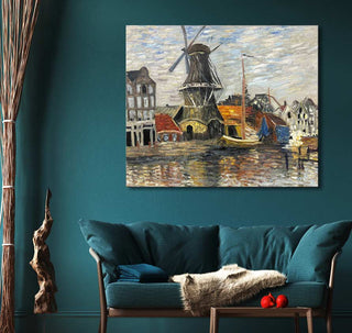 Claude Monet's Molen op de Onbekende Gracht in Amsterdam impressionist painting, depicting a riverside windmill and harbor, elegantly displayed above a teal loveseat.