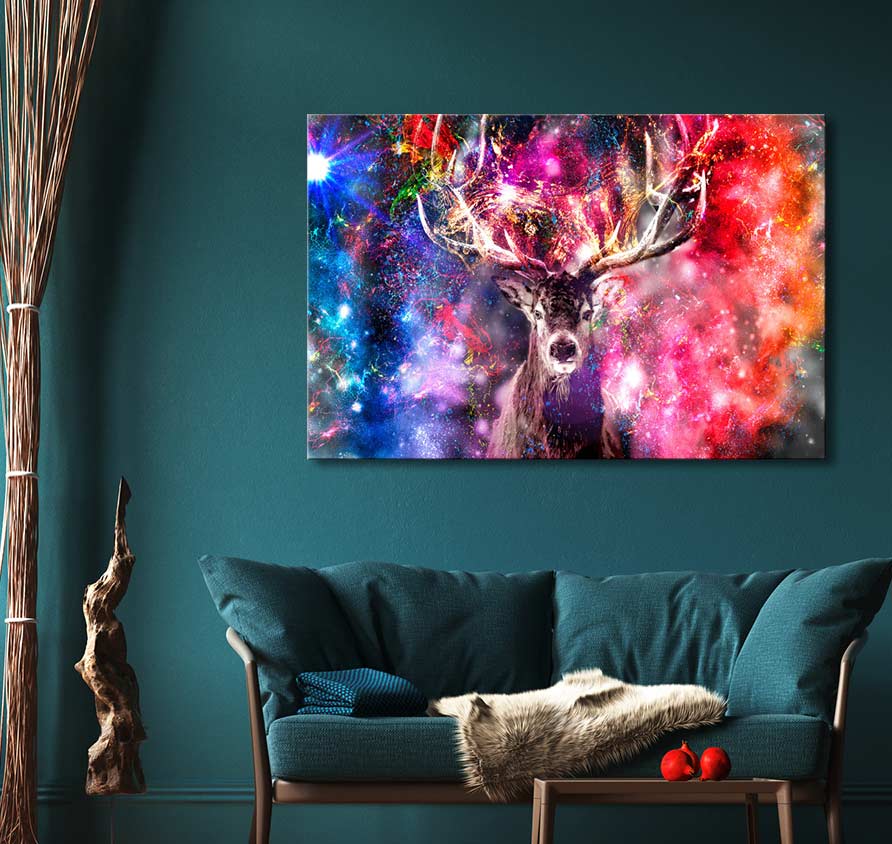 Teal sofa with faux-fur blanket beneath colorful canvas “Hert - Olieverf op canvas,” depicting a stag in a cosmic nebula, enhanced by impressionistic artistry.
