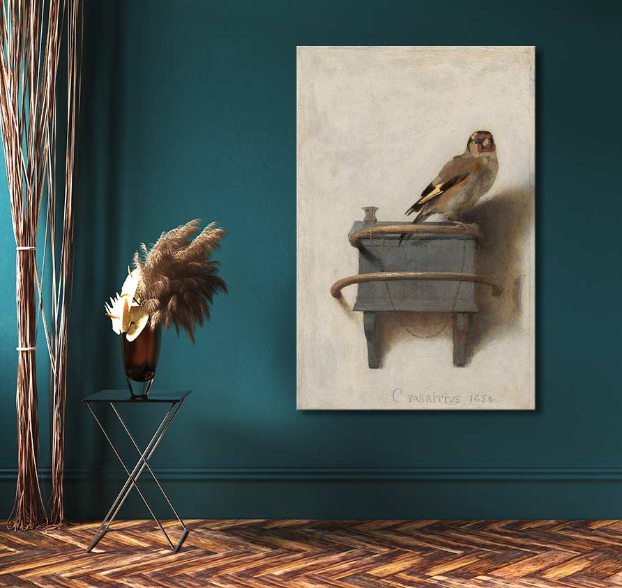 Carel Fabritius's The Goldfinch reproduction, hand-painted oil on canvas, displayed on a deep teal wall, beside a black side table with dried grasses.