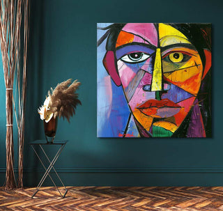 Cubist-inspired painting Picasso signature - Zelfportret on teal wall, alongside black metal table with dark vase and dried plumes, enhancing modern-classic decor.