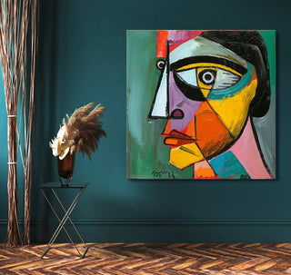 Cubist-style painting titled Pablo Picasso's Alter Ego, showcasing an abstract face in vivid colors. Displayed on a deep teal wall, enhancing contemporary interior decor.