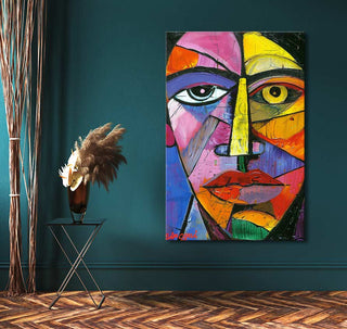 Abstract portrait painting, Picasso Signature - Abstract Hoofd, on teal wall; features bold geometric forms. Accompanied by a black side table with vase and dried stems.