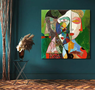 Abstract cubist painting, Picasso signature - Dora Maar, featuring two geometric faces. Displayed in a modern setting with a side table and pampas grass arrangement.