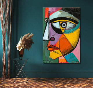 Picasso signature 'Portret van Ambroise Vollard,' bold abstract portrait in vibrant colors, displayed in a modern setting with dried grasses on a black metal table.