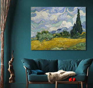 Vincent van Gogh - Korenveld met Cipressen canvas print above a teal sofa, adding impressionistic charm to a cozy living-room corner with wooden accents.