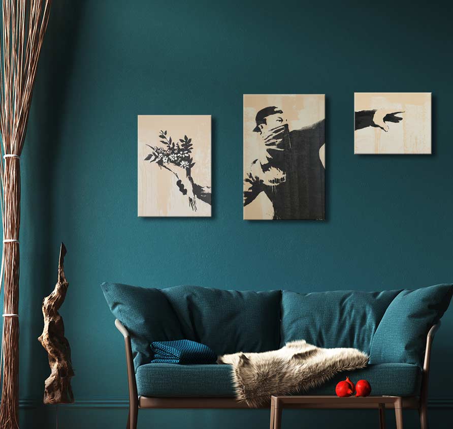 Banksy - The Riot (3-piece): A triptych featuring a stencil-style figure throwing flowers, set against a teal living room with a cozy, modern aesthetic.