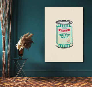 Banksy - Value Tomato Soup pop art painting on teal wall, featuring a can of tomato soup, complemented by a black metal table with dried grasses.