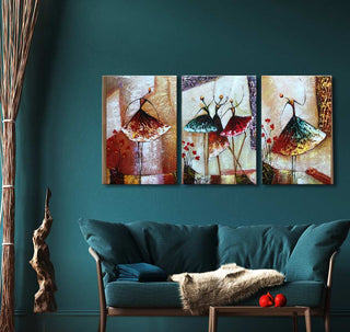 Triptych oil painting Vreugdedans showing five abstract dancers with colorful skirts, displayed above a teal sofa. Hand-painted on museum-quality canvas.