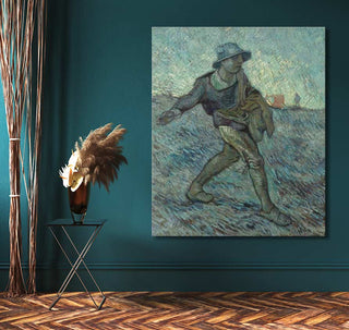 Vincent van Gogh's The Sower reproduction on teal wall, with rustic décor elements, including a black metal table and pampas grass, enhancing modern interior design.